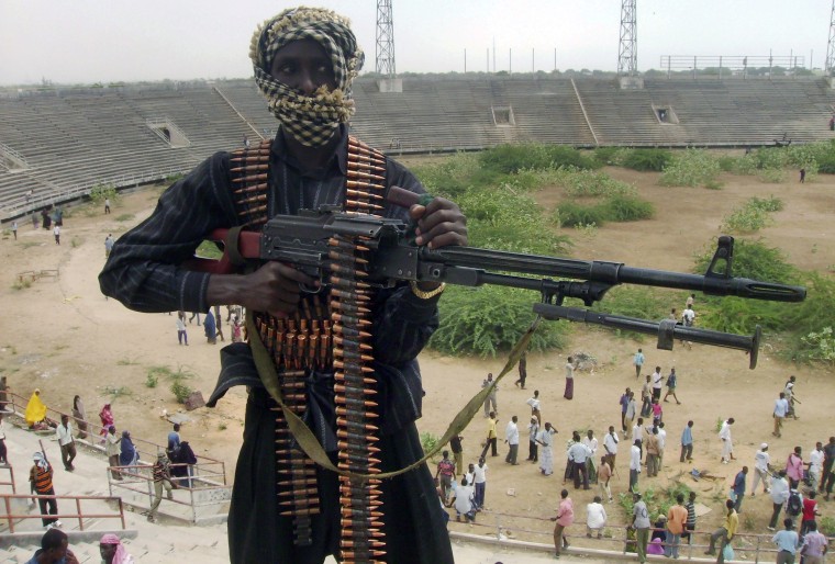 Image: File photo of an Islamist insurgent holding his machine gun in the stadium in Mogadishu