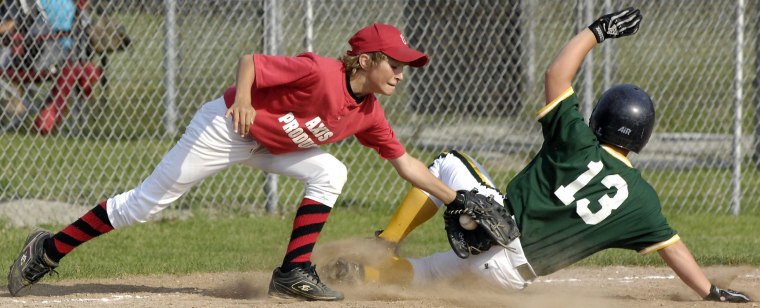 Concord pitcher Josh Hudnall, left, applies a late tag as Mishawaka's Anthony Piraccini slides safely into third base during action at Baugo on June 12, 2008.