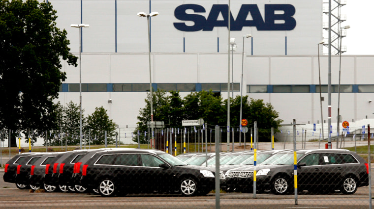 Image: New Saab automobiles are parked in a storage lot outside the main factory in Trollhattan