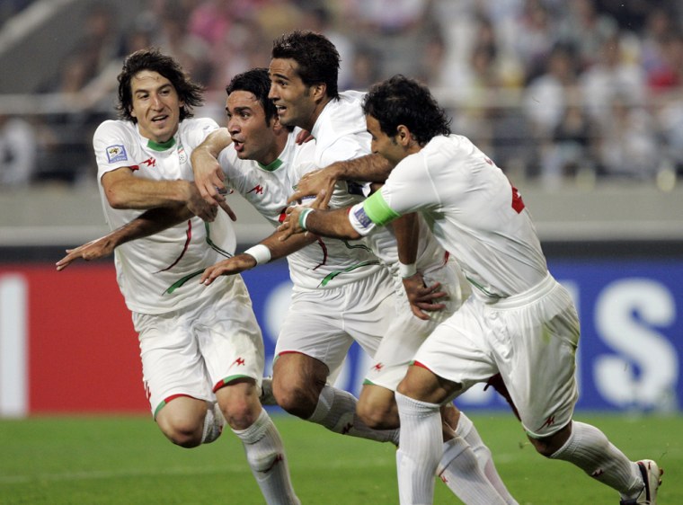 Image: Iran's Masoud Shojaye celebrates with his teammates after scoring a goal