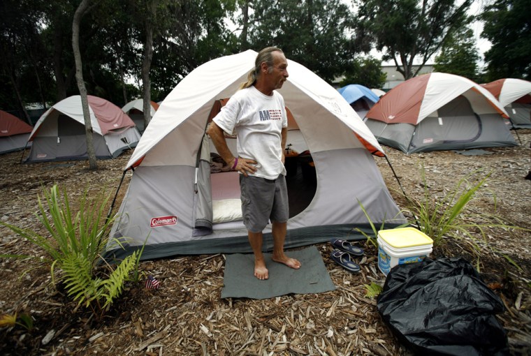 Image: Eric Waterman stands outside his tent at the Pinellas Hope tent city homeless community, in Pinellas Park, Florida