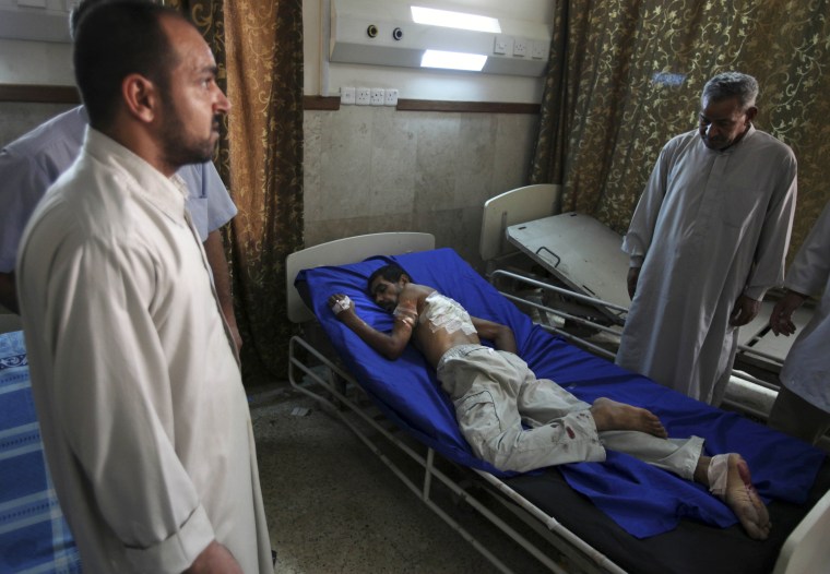 Image: An injured man is visited by relatives