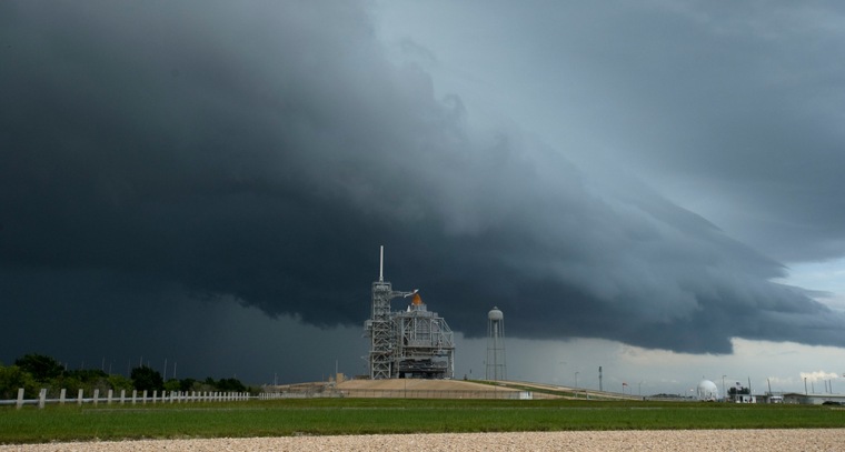 Storm clouds approach Launch Pad 39A at NASA's Kennedy Space Center in Florida on Friday as the space shuttle Endeavour stands within its service structure, ready for launch on Saturday if the weather cooperates.