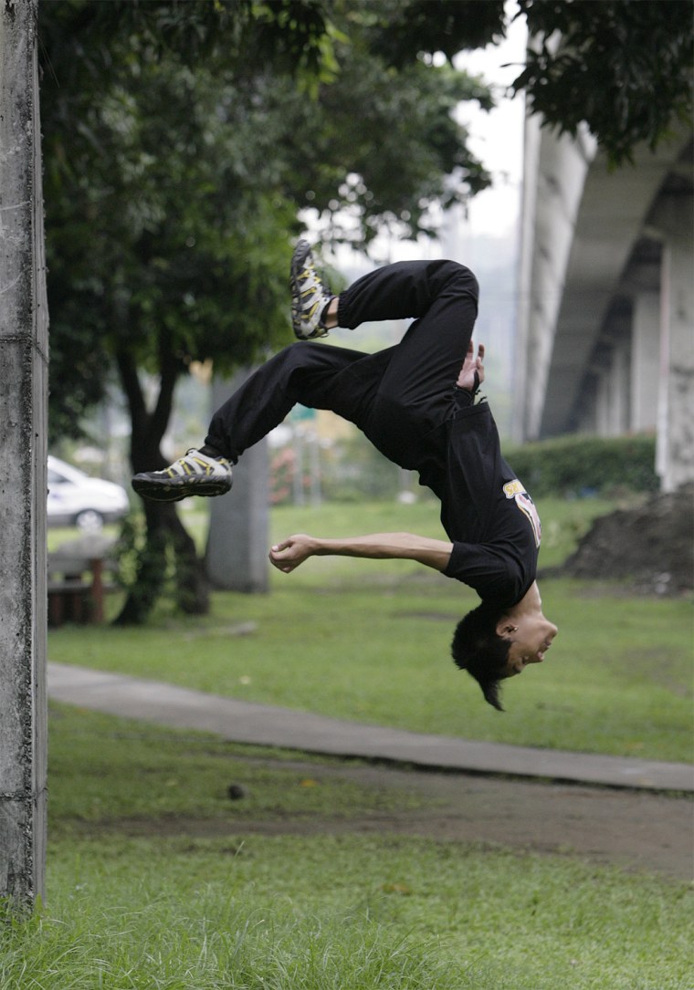 A Parkour practitioner performs a backflip in a public park in Marikina, metro Manila