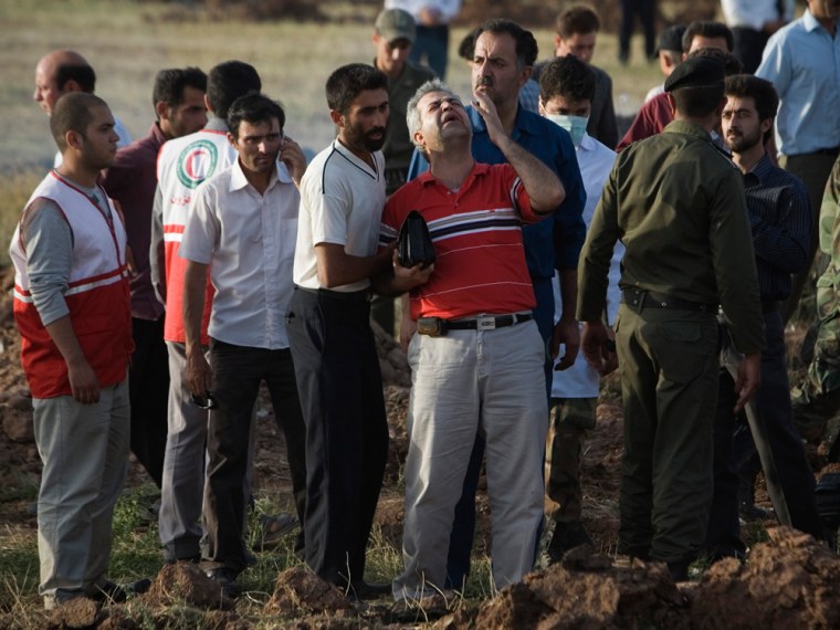 Image: A relative grives at the crash site.