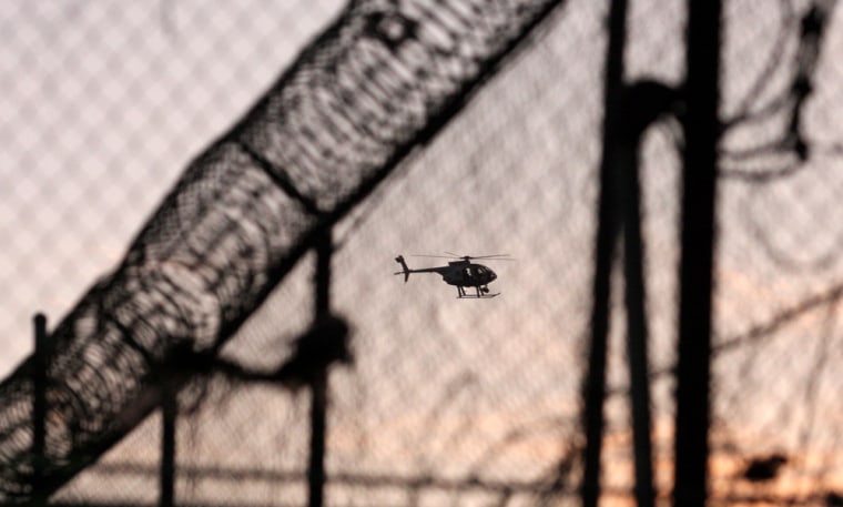 Image: A police helicopter flies over a Juvenile Detention Center after inmates escaped in Tijuana