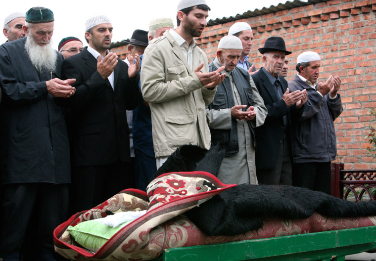 Image: People pray during Zarema Sadulayeva's funeral