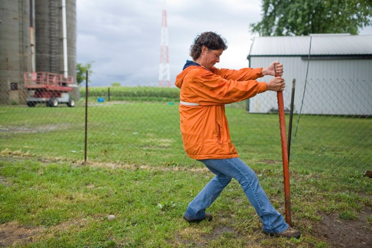 Becky Cutter loosens an old fencepost at her landlord's rural property, which she maintains in exchange for housing. After losing her job in Feb. 2007 at a horse trailer facility, she received unemployment benefits which ran out nearly two months ago.