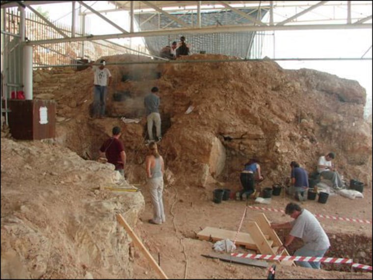 Anthropologists work to excavate Qesem Cave, where early human hunters carved up their prey. The cave was discovered in Israel about nine years ago. 