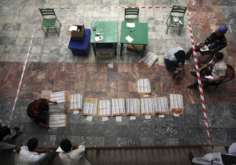 Image: Afghan election workers count ballots at a mosque