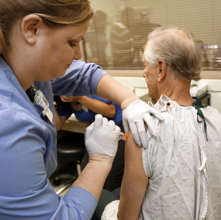 Image: Dr. William Schaffner, chair of the department of preventive medicine at Vanderbilt University Medical Center in Nashville, Tenn., is given a dose of the experimental vaccine for the H1N1 flu virus by Research Nurse Erin Keckley