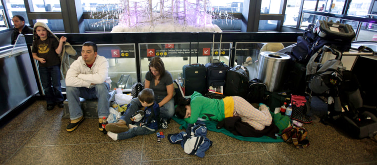 Image: Passengers sleep in airport