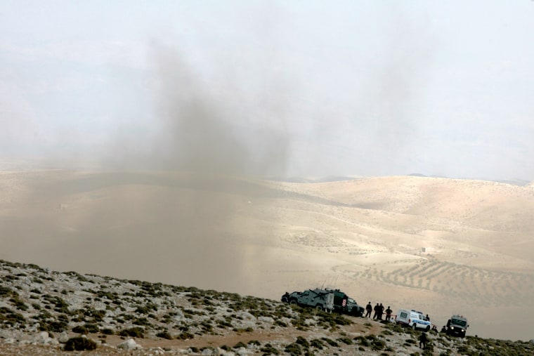 Image: Smoke billows from the crash site of an Israeli fighter jet
