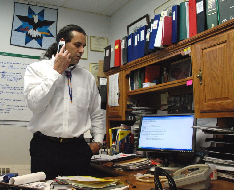 Image: Cheyenne River Sioux Tribe attorney Tom Van Norman talks on the telephone about the tribe's lawsuit against the local school district in his office in Eagle Butte, S.D.
