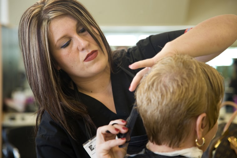Cosmetology student Cindy Koehler cuts Jennette Terry's hair at Elkhart Beauty College, where she's about halfway through a 1500-hour program.  Koehler had been interested for years in cosmetology, but didn't find the opportunity to pursue it as a career until being laid off from her sales job in the RV industry at National Supply.