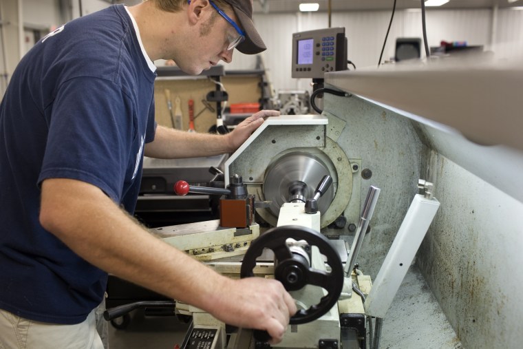 Travis Wagner works with a lathe at the new Ivy Tech Orthopedic and Advanced Manufacturing Training Center in Warsaw, Ind. Wagner, who lost his job with the RV maker Monaco Coach, in April 2008, said he's "less and less" confident that he'll be able to find work when he graduates next May.