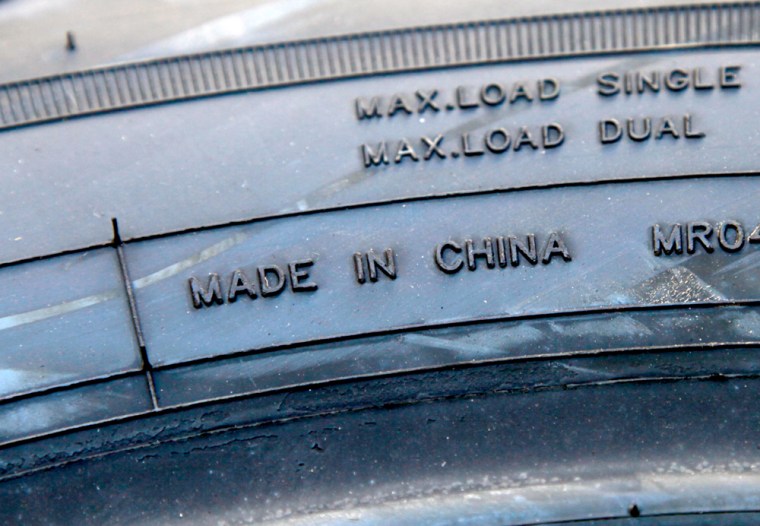Image: A Chinese-made tire sits outside of the Redco Tire Inc. dealer in Denver