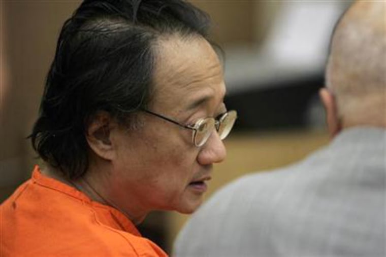 Image: Norman Hsu (L) speaks with his attorney, James Brosnahan, inside a courtroom in Redwood City