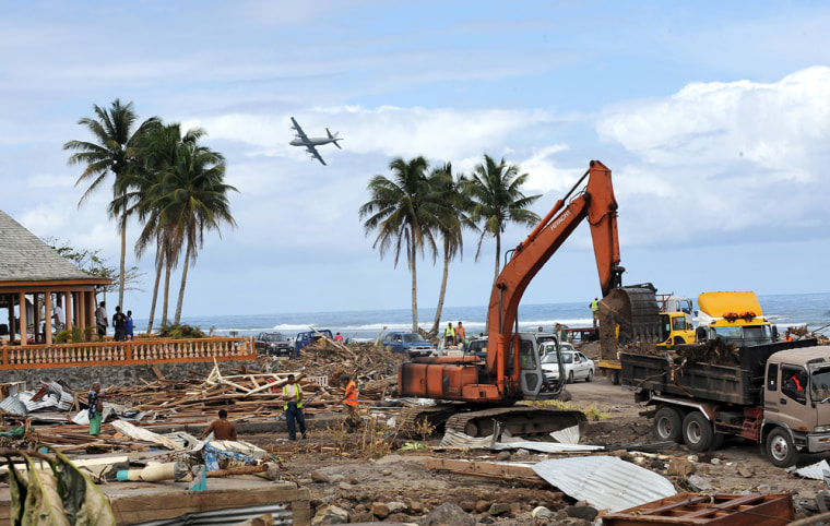 Image: A New Zealand Air Force plane surveys the damage over the southern coast of Samoa