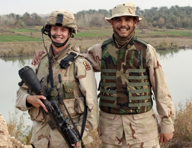 **ADVANCE FOR MONDAY, OCT. 12** This Dec. 23, 2005 photo released by Joey Coon shows Coon, left, and his translator at the time, Bandar Hasan, beside the Tigris River in Iraq. (AP Photo/Joey Coon) **NO SALES**