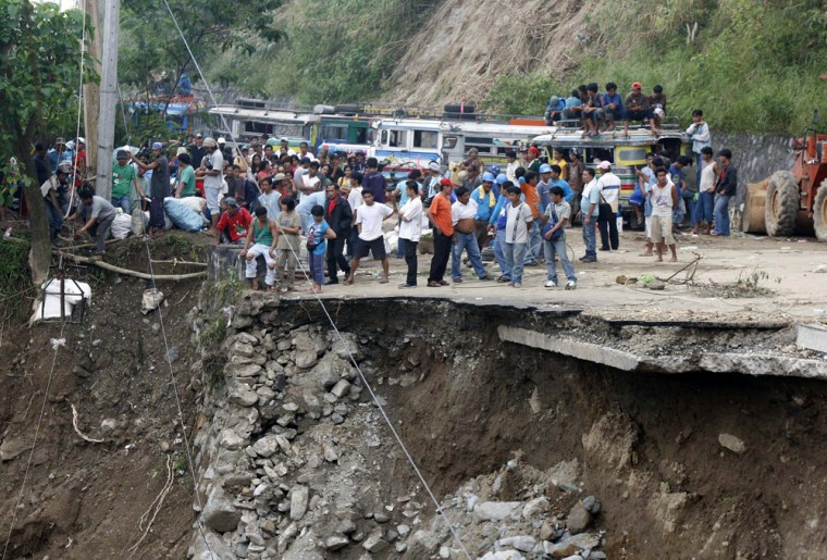 Image: The death toll from massive landslides and floods brought about by a typhoon in the northern Philippines climbed Sunday to nearly 300