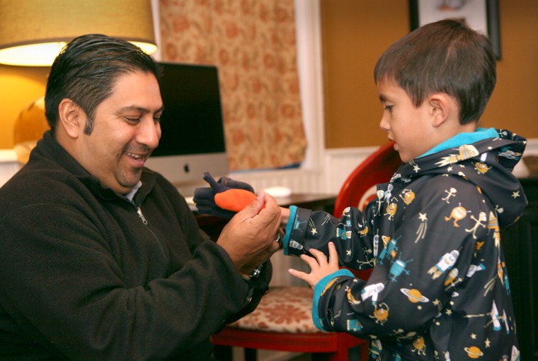 Image: Image: Steve Flores prepares son Joaquin, \"Quino,\" age 6, for school.