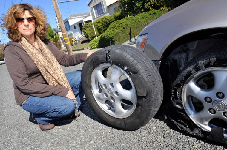 Image: Andrea Nelson shows her car's flat front tires