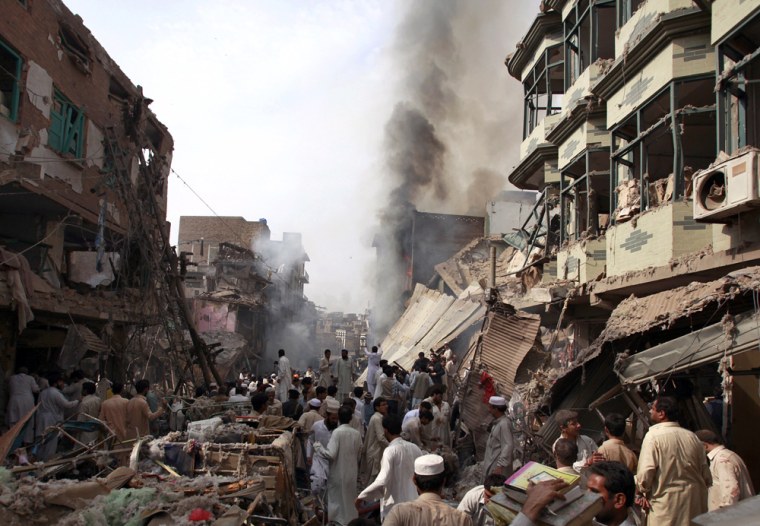 Image: Residents, rescue workers and security officials gather after a bomb explosion in Peshawar