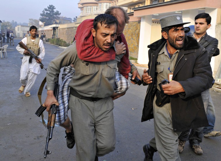 Image: An injured man is carried by police