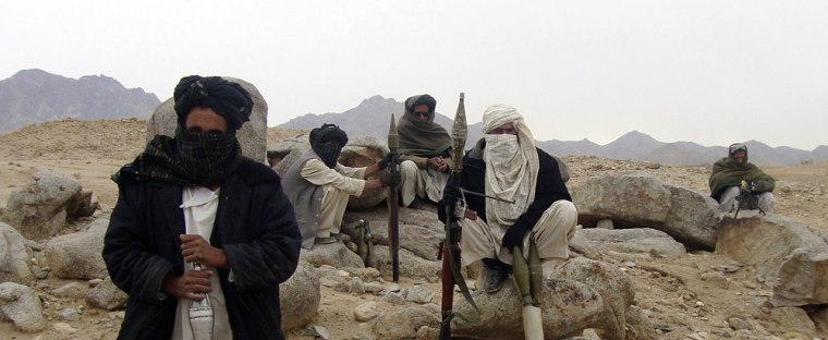 Image: Taliban fighters pose with weapons in an undisclosed location in Afghanistan