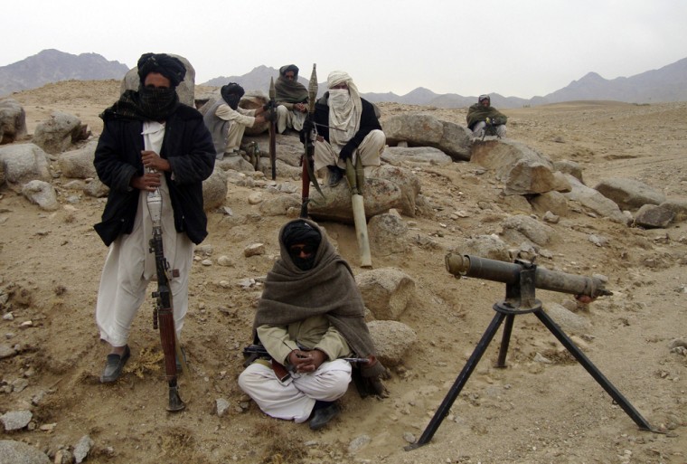 Image: Taliban fighters pose with weapons in an undisclosed location in Afghanistan