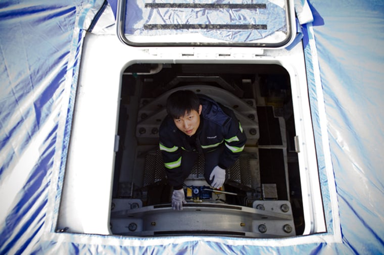 A worker inside a wind turbine at a factory in Tianjin, China.