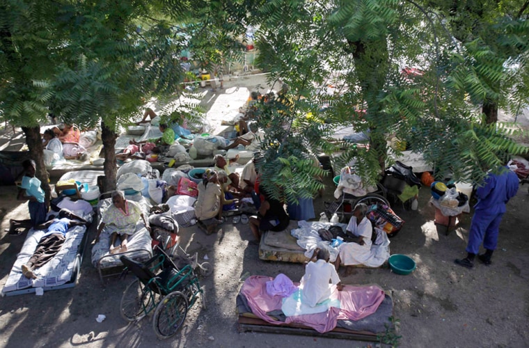 Image: Patients lay camped outside their quake damaged nursing home in Port-au-Prince