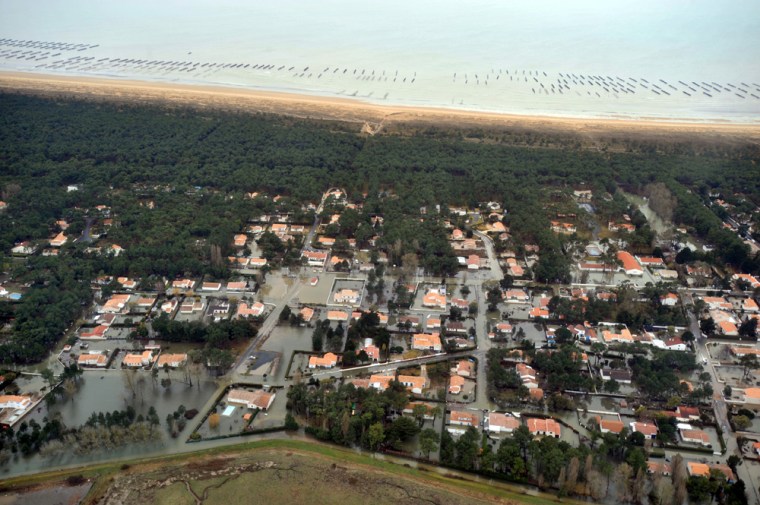 Image: Aerial view taken shows flooded houses and streets on the Atlantic seaboard