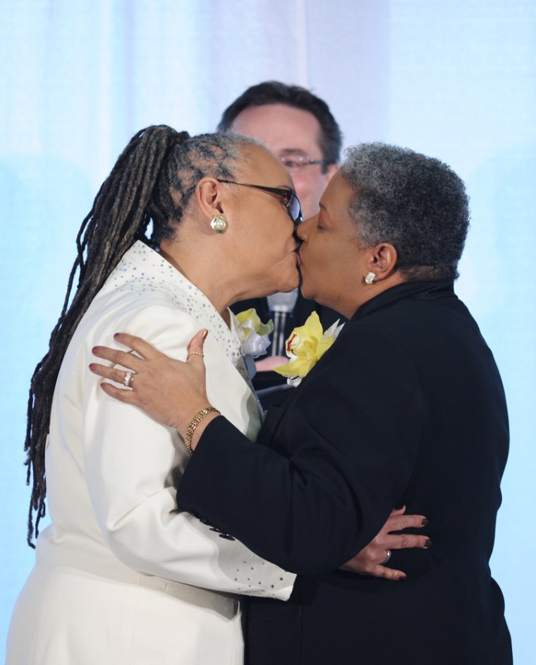 Image: Same sex couple Darlene Garner and Lorilyn Candy Holmes kiss after taking their vows
