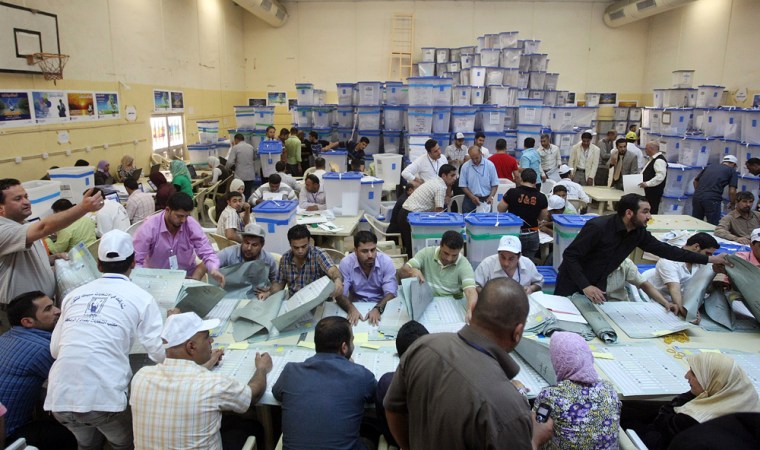 Image: Iraqis count votes at the Independent High Electoral Commission headquarters in Baghdad