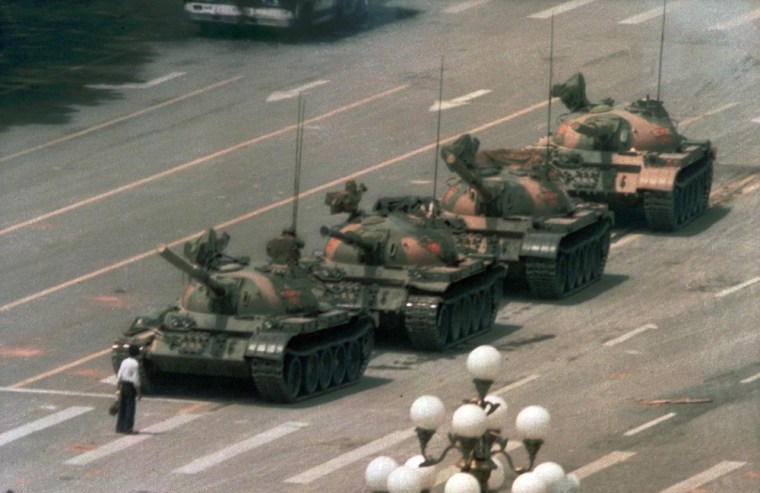 Image: A Chinese man stands alone to block a line of tanks in Tiananmen Square