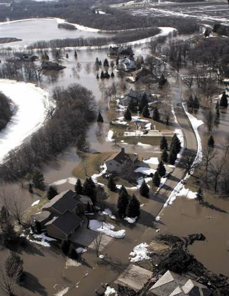 Image: The Red River floods properties Wednesday in the area of Wild Rice, N.D., south of Fargo.