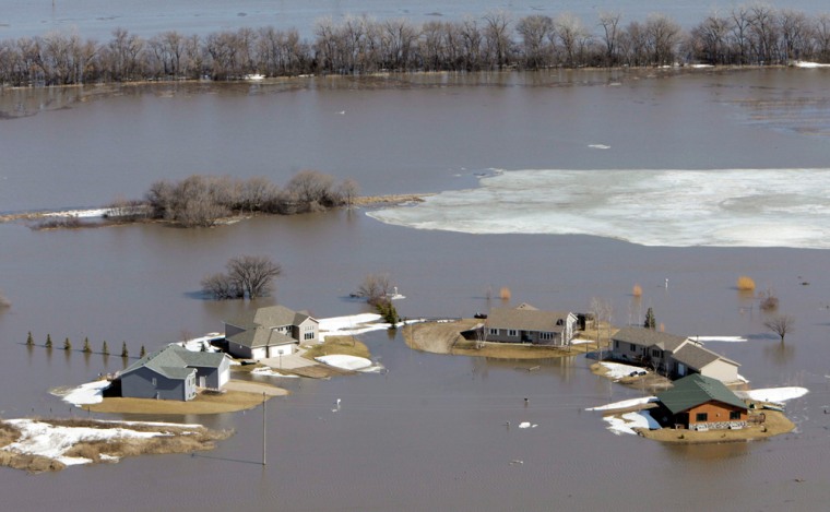 Image: Homes in the Lake Shore subdivision are surrounded by flood waters