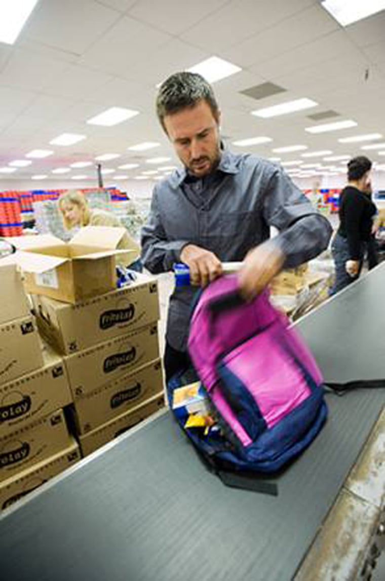 David Arquette, chairman of Feeding America’s Entertainment Council, packs backpacks with donated food for the LA Regional Food Bank.