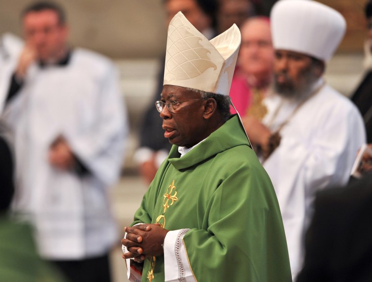 Nigerian Cardinal Francis Arinze (C) att