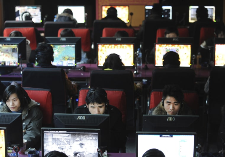 Image: People use computers at an internet cafe in Wuhan