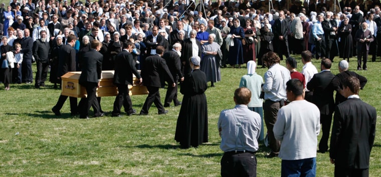 Image: The casket of one of the Esh family members is carried to the burial site in Marrowbone, Ky.