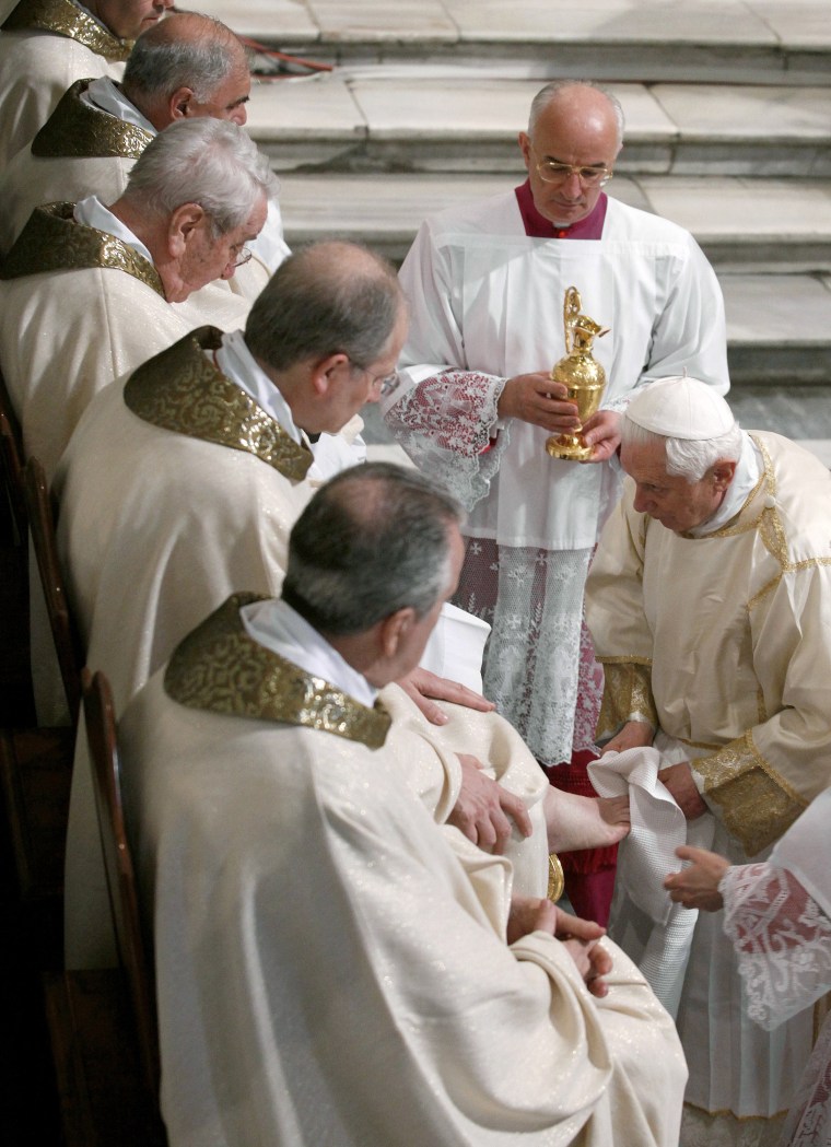 Image: Pope Benedict XVI washes the foot of a priest during the Cena Domini mass at the Vatican's Basilica of Saint John Lateran in central Rome
