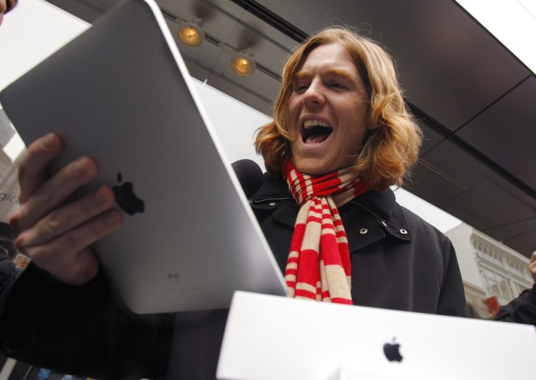 Image: Andreas Schobel reacts after being among the first to purchase an Apple iPad