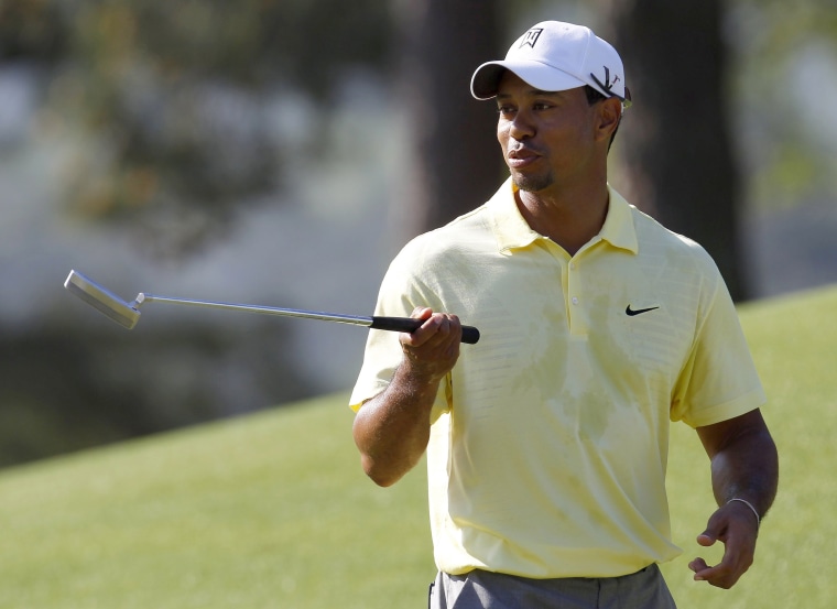 Image: Tiger Woods of the U.S. walks across the eighth green during a practice round for the 2010 Masters golf tournament at the Augusta National Golf Club in Augusta