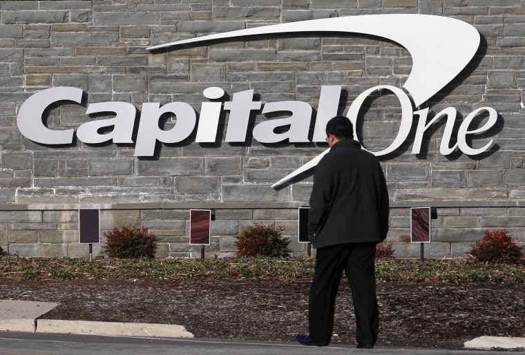 Image: A man walks to a Capital One building