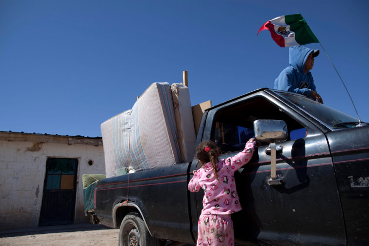 Image: A family leaves their home in Guadalupe after drug cartel members threat residents