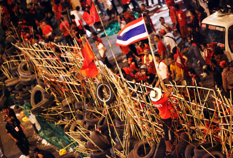Red Shirt supporters build a barricade on Silom street in Bangkok on Wednesday. The army have vowed not to let the protestors move, warning that they will use decisive measures to get control of the streets.