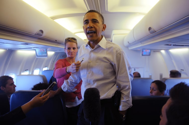 Image: US President Barack Obama speaks with traveling journalists on board Air Force One